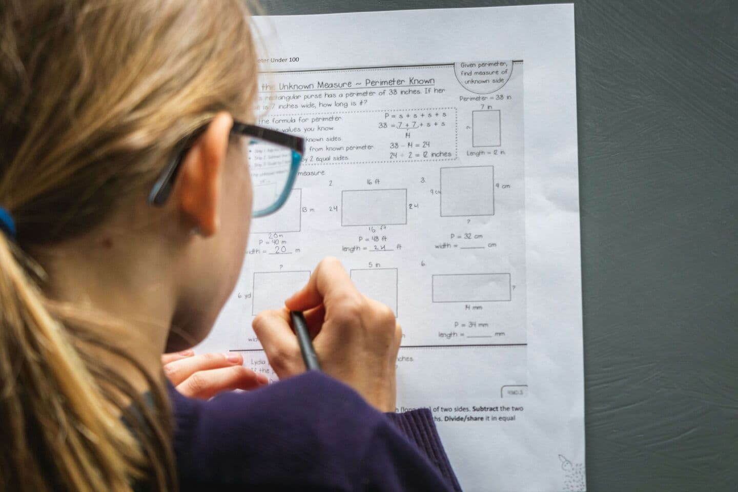 Student working through a math assessment worksheet